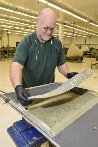 Michael Potter, 553rd Commodities Maintenance Squadron composite fabricator, places a section of aluminum honeycomb in to place on a section of B-1B flight control surface being repaired at the Oklahoma City Air Logistics Complex, July 25, 2016, Tinker Air Force Base, Okla. The 553rd CMMXS manufactures and maintains components for KC-135, B-1B, B-52H, E-3 and E-6 aircraft. (U.S. Air Force photo/Greg L. Davis)